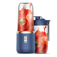 Portable blender with a blue base and red fruit design on the container against a white background
